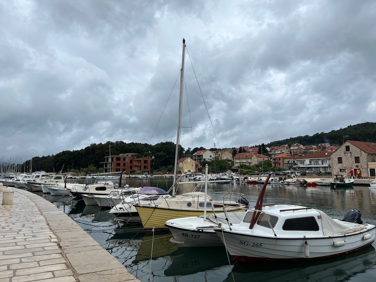 A row of small fishing boats docked in the Bay in the town of Stari Grad Croatia.